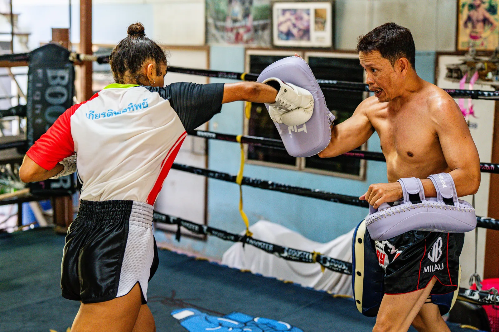 Woman training kicks on the pads